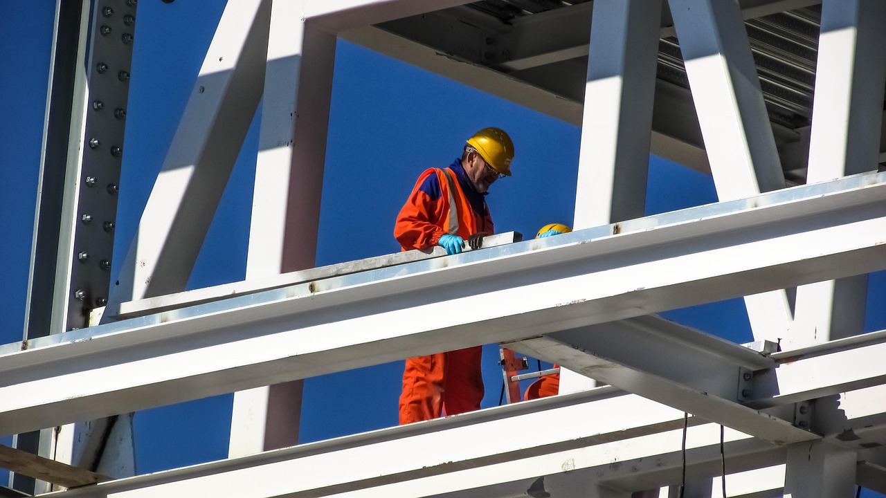 Construction worker in a hard hat reviewing plans on a job site
