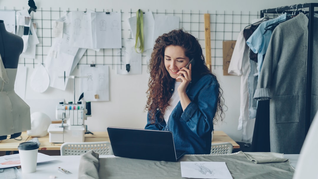 A small business owner reviewing paperwork and a laptop while preparing a bid