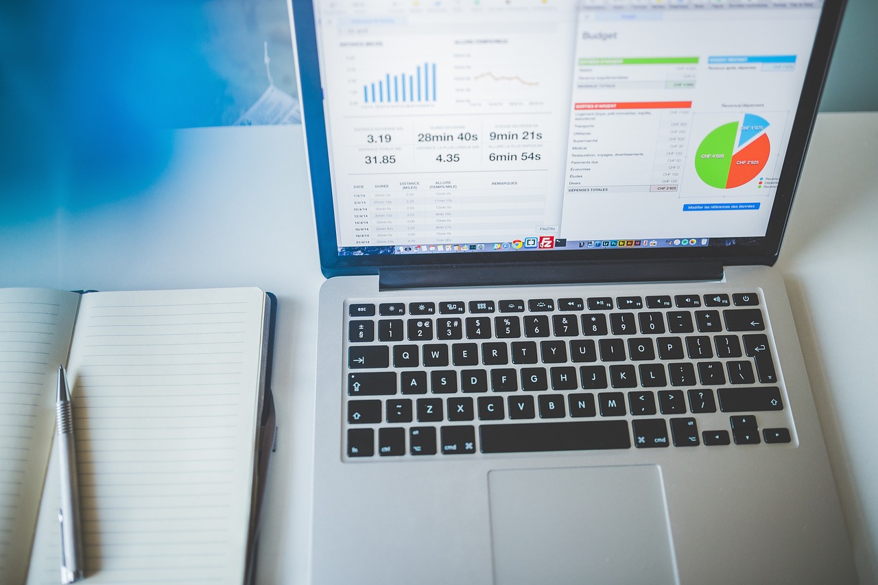 Person working on a laptop displaying business charts and analytics data