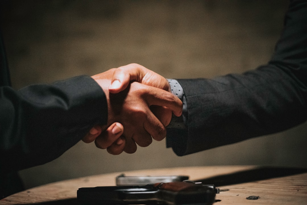 Two people shaking hands after a successful business meeting