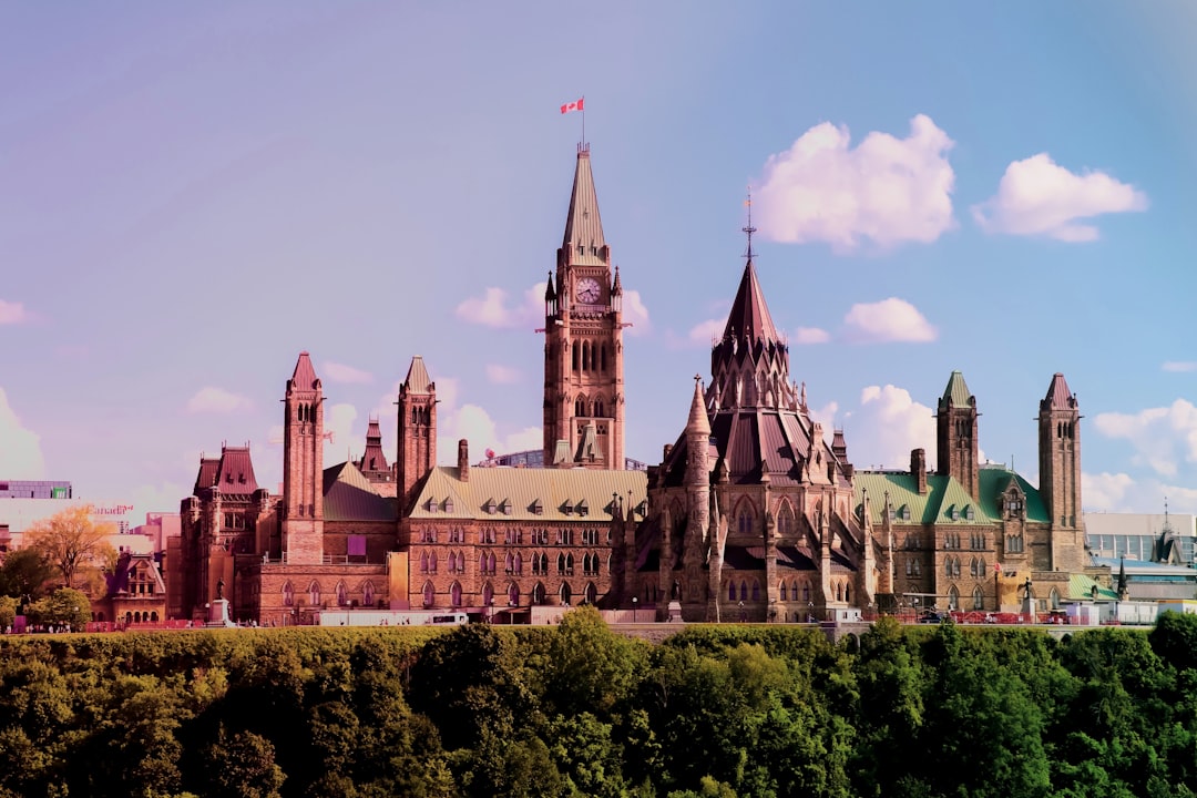 Parliament Hill and the Peace Tower in Ottawa under a daytime sky