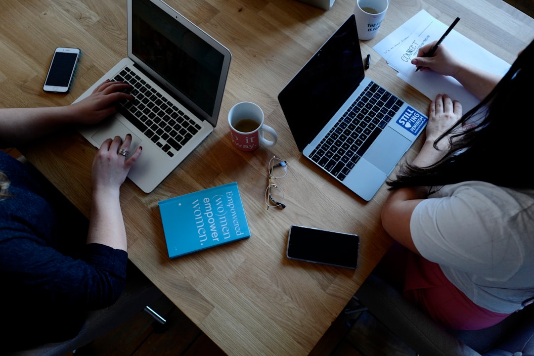 Team writing a proposal document together on a laptop
