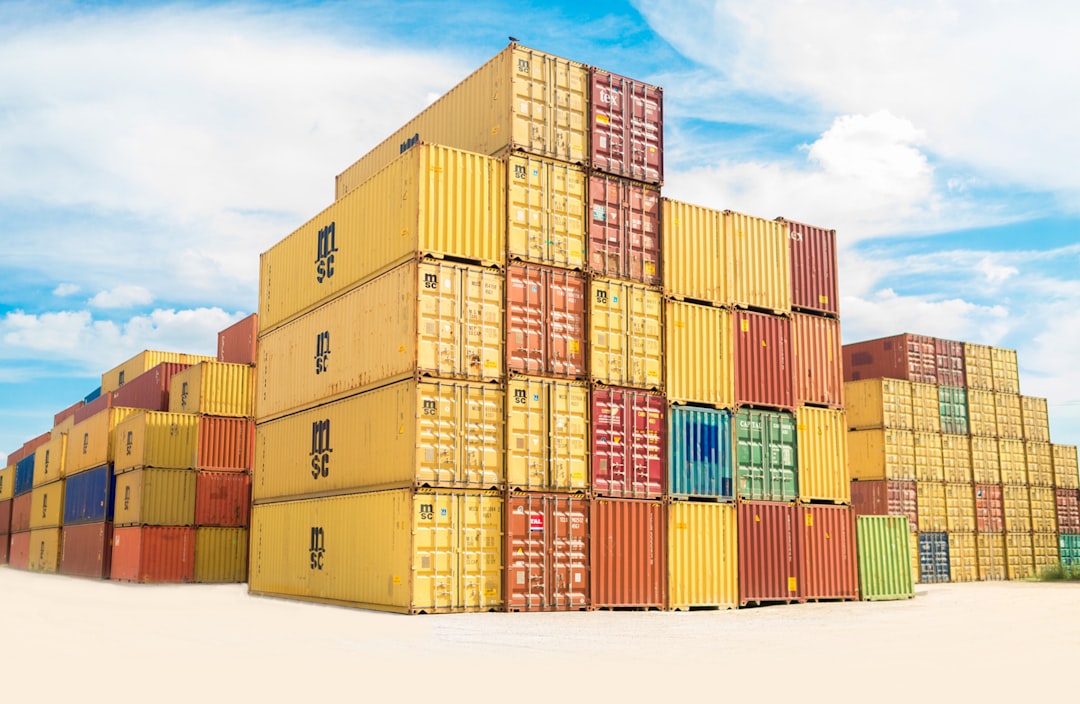 Stacked shipping containers at a port, representing cross-border trade under CUSMA
