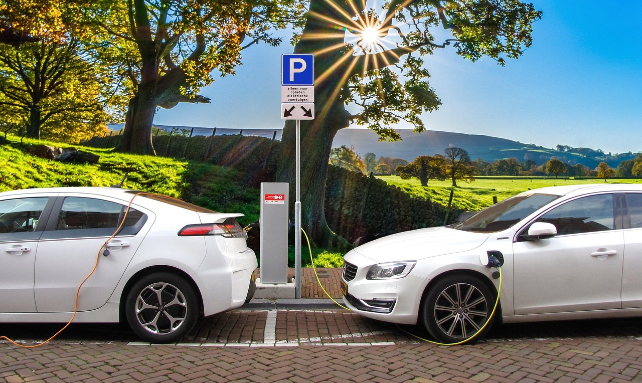 An electric vehicle plugged into a charging post outdoors