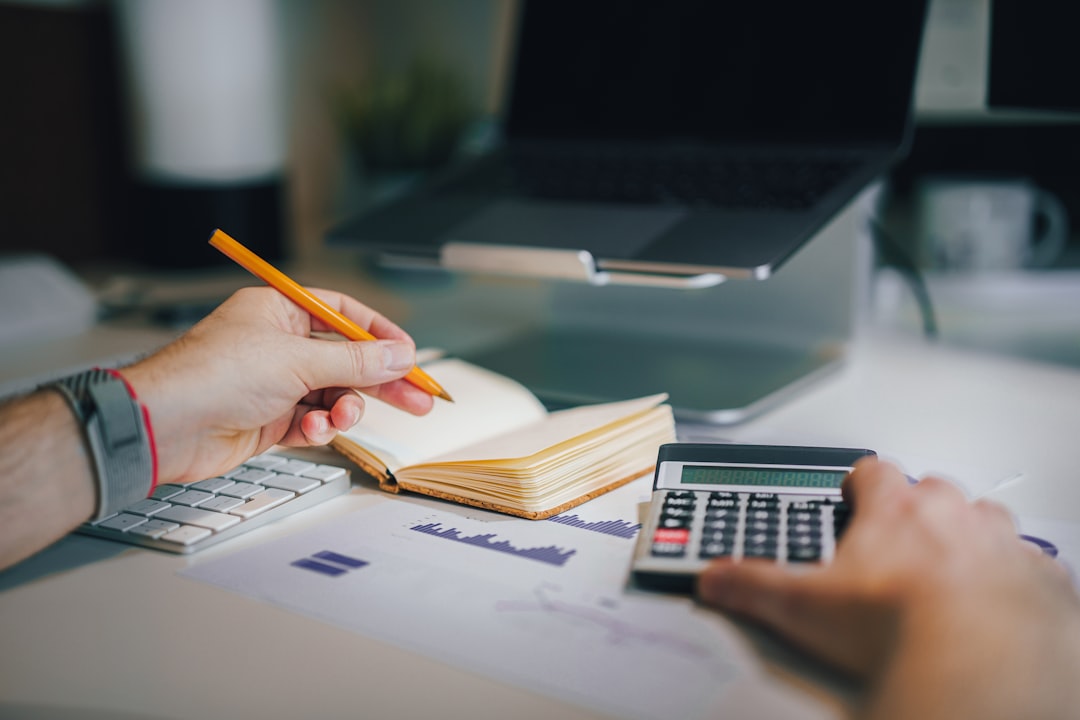 Person filing paperwork at an office desk