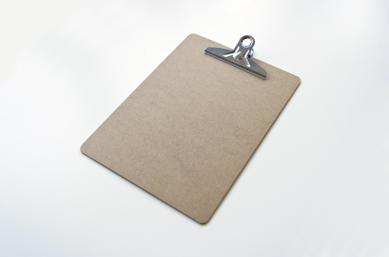 A checklist on a clipboard resting on an office desk, used for scoring criteria