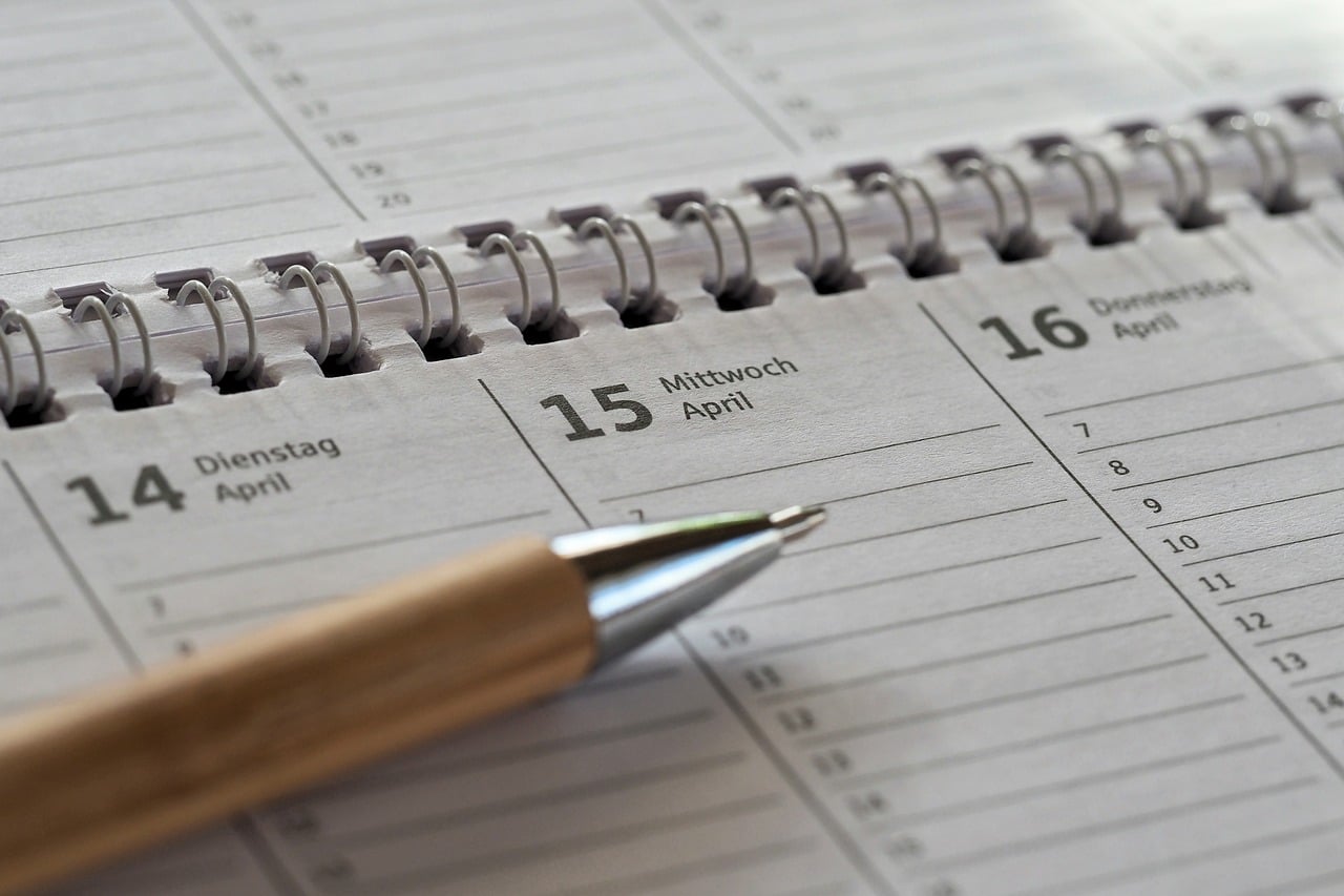 A desk calendar and planner used to track contract end dates and extension deadlines
